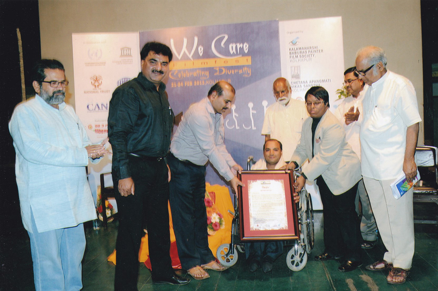 Collector of Kolhapur felicitating Mr. Nilesh Chhadawelkar with Nirdhar Award given by Helpers of Handicap, Chetana Apangmati Vikas Sanstha, Lakamaharshi Baburao Penter Film Society, Kolhapur at Kolhapur